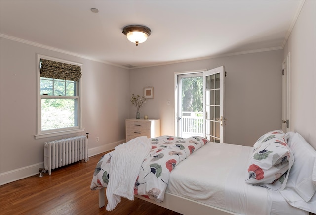 bedroom with radiator heating unit, multiple windows, ornamental molding, and access to outside