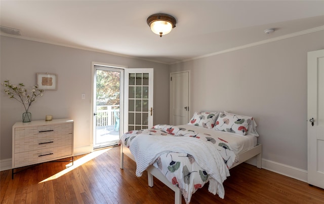 bedroom with crown molding, baseboards, wood finished floors, and access to exterior