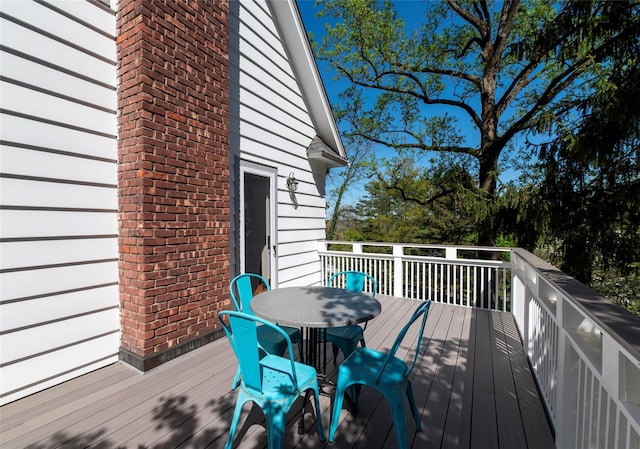 wooden terrace with outdoor dining area