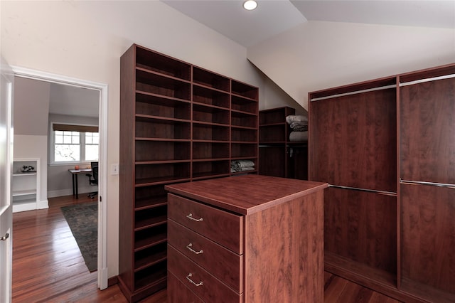 walk in closet featuring dark wood-style flooring and lofted ceiling