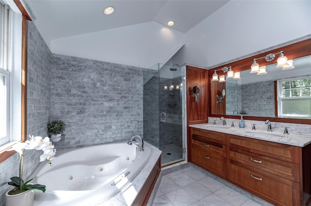 full bath featuring a whirlpool tub, a sink, a stall shower, and double vanity