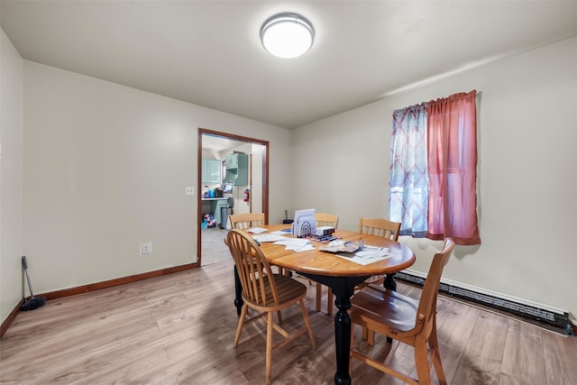 86 Linden Ave, Middletown, NY 10940 - dining room featuring a baseboard radiator, light wood-style flooring, and baseboards