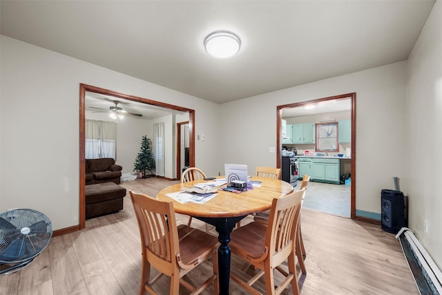 86 Linden Ave, Middletown, NY 10940 - dining area featuring a baseboard radiator, light wood-type flooring, baseboards, and a ceiling fan