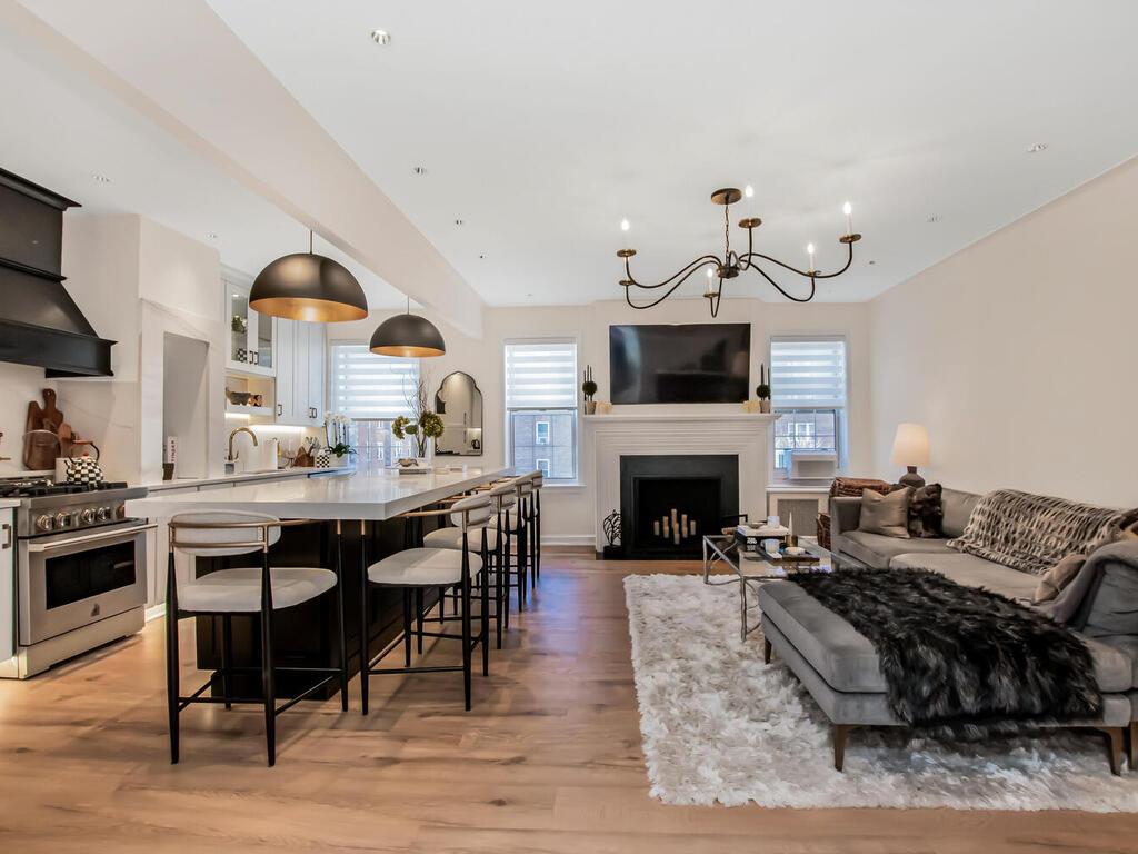 living area with a chandelier and light wood finished floors