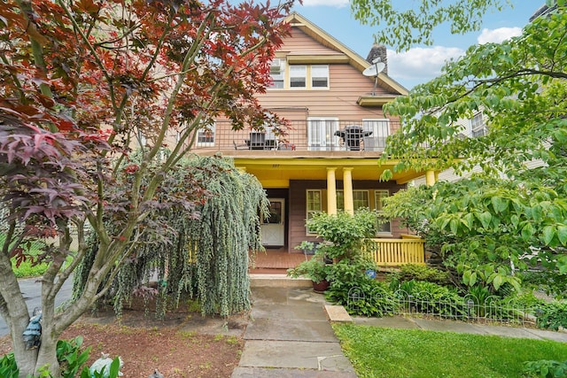 227 Valentine Ln, Yonkers, NY 10705 - view of front facade with a balcony, a porch, and a chimney