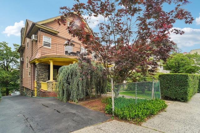 227 Valentine Ln, Yonkers, NY 10705 - view of front of property featuring a balcony, stone siding, and a porch