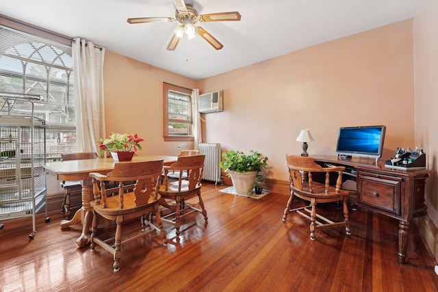 227 Valentine Ln, Yonkers, NY 10705 - dining space with radiator heating unit, a wall unit AC, wood finished floors, and a ceiling fan