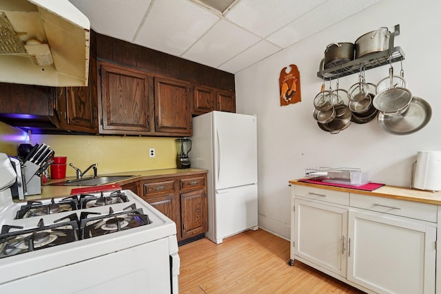 227 Valentine Ln, Yonkers, NY 10705 - kitchen featuring white appliances, a paneled ceiling, light wood-style floors, light countertops, and white cabinets