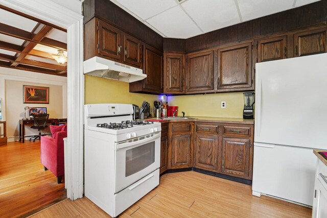 227 Valentine Ln, Yonkers, NY 10705 - kitchen featuring white appliances, under cabinet range hood, light wood-style floors, coffered ceiling, and beam ceiling
