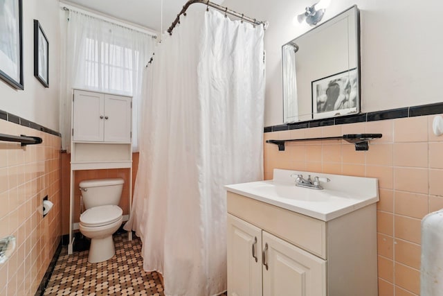 227 Valentine Ln, Yonkers, NY 10705 - bathroom with tile walls, vanity, wainscoting, and a shower with shower curtain