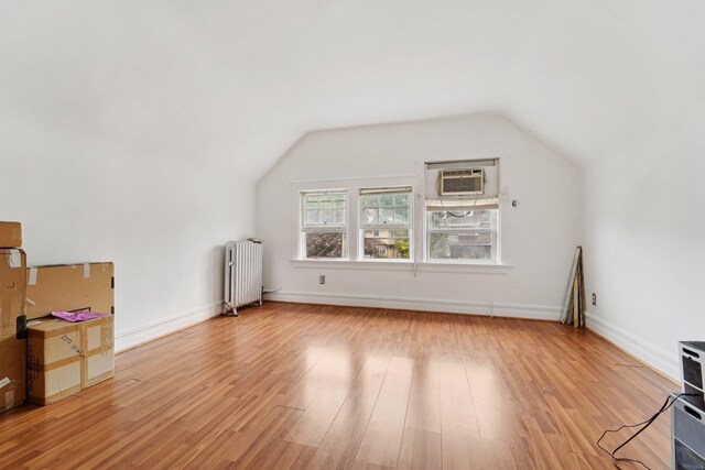 227 Valentine Ln, Yonkers, NY 10705 - bonus room featuring radiator heating unit, a wall unit AC, light wood-style floors, and vaulted ceiling