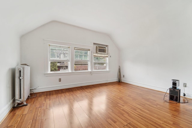 227 Valentine Ln, Yonkers, NY 10705 - additional living space with radiator, vaulted ceiling, and light wood-style flooring