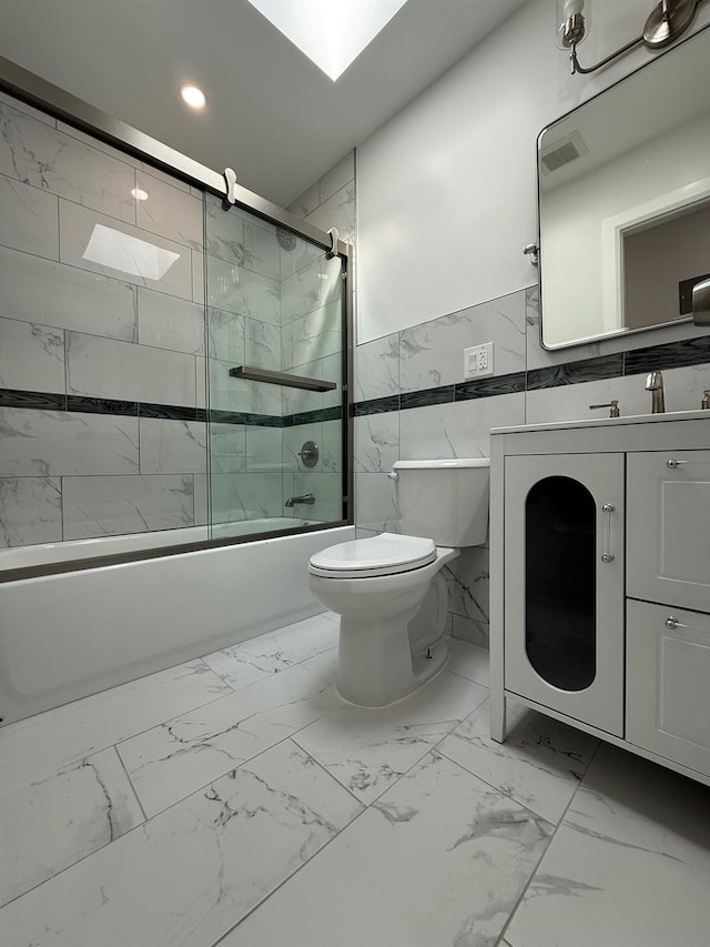 full bathroom featuring marble finish floor, toilet, shower / bath combination with glass door, and recessed lighting