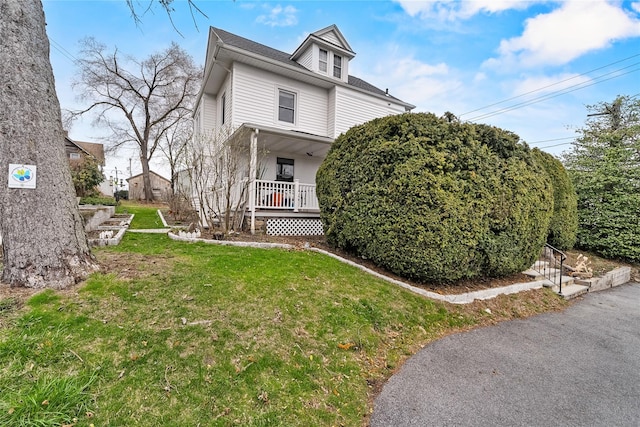 view of front of home featuring a porch and a front lawn