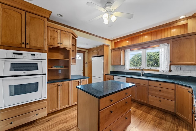 kitchen with open shelves, a sink, white appliances, and light wood-type flooring