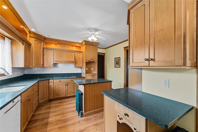 kitchen featuring ceiling fan, gas stovetop, a sink, white dishwasher, and decorative backsplash