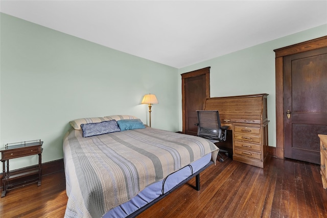 bedroom featuring baseboards and dark wood-style floors