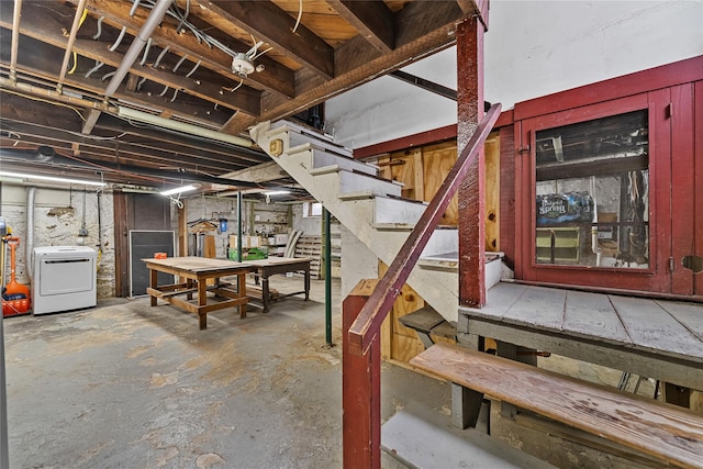 unfinished basement with washer / clothes dryer and stairs