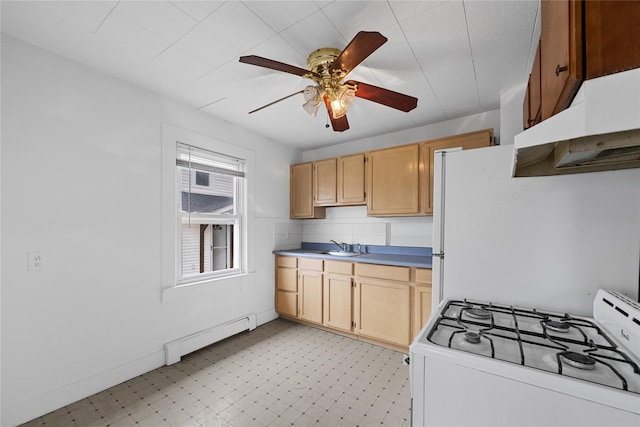 kitchen featuring under cabinet range hood, white appliances, baseboard heating, and light floors