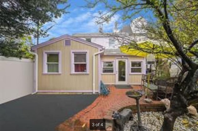 rear view of property with fence