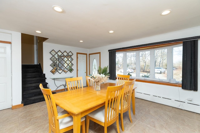 dining space featuring recessed lighting, a baseboard heating unit, and stairs