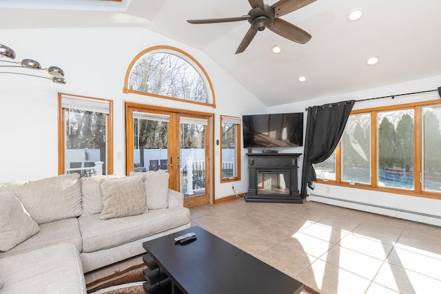 tiled living area featuring a ceiling fan, a baseboard heating unit, recessed lighting, and a healthy amount of sunlight
