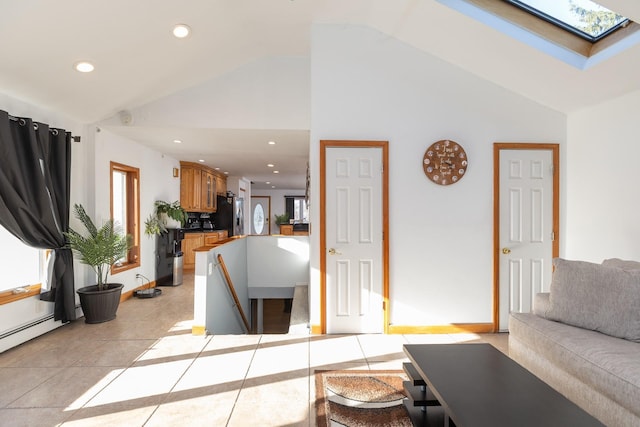 living room with high vaulted ceiling, a skylight, light tile patterned floors, baseboards, and recessed lighting