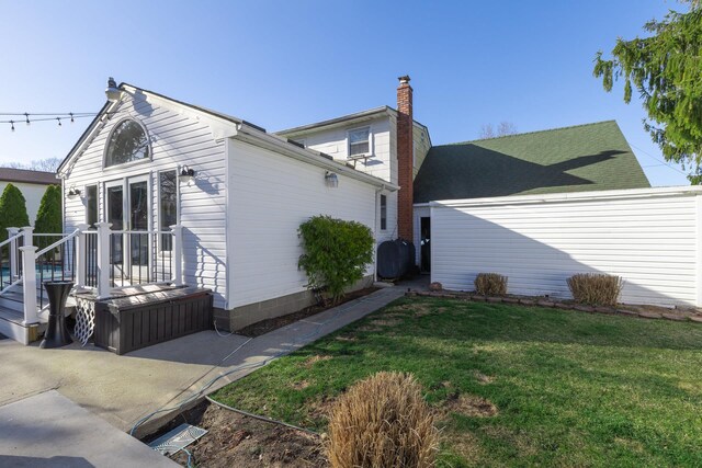 exterior space with a chimney and a yard