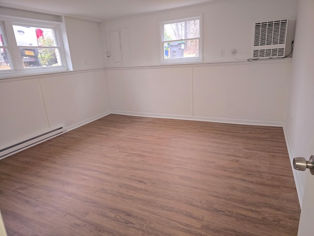 51 Glenerie Ln, Saugerties, NY 12477 - unfurnished room featuring plenty of natural light, wood finished floors, a wall mounted AC, and baseboard heating