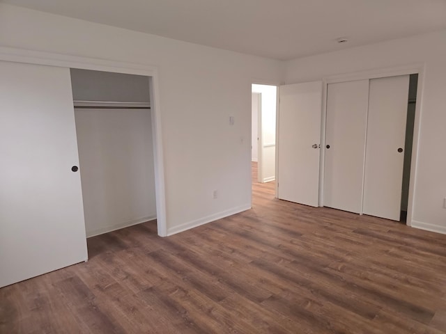 51 Glenerie Ln, Saugerties, NY 12477 - unfurnished bedroom with multiple closets, wood finished floors, and baseboards