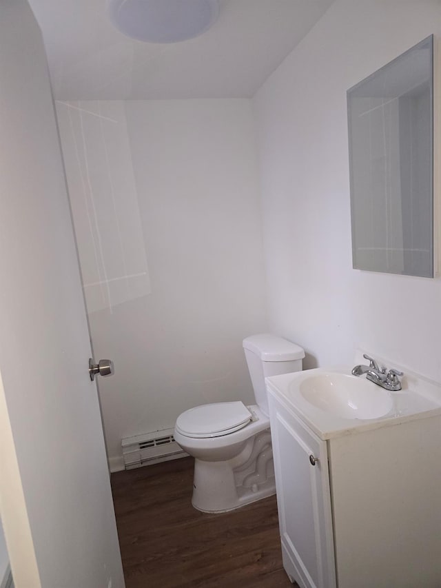 51 Glenerie Ln, Saugerties, NY 12477 - bathroom featuring baseboard heating, vanity, wood finished floors, and toilet