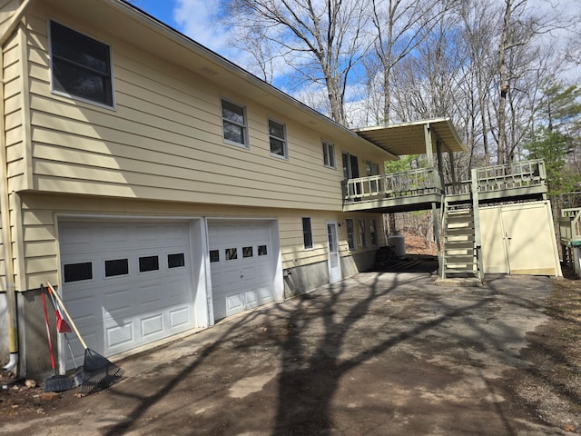 51 Glenerie Ln, Saugerties, NY 12477 - view of side of property with asphalt driveway, an attached garage, a wooden deck, and stairway