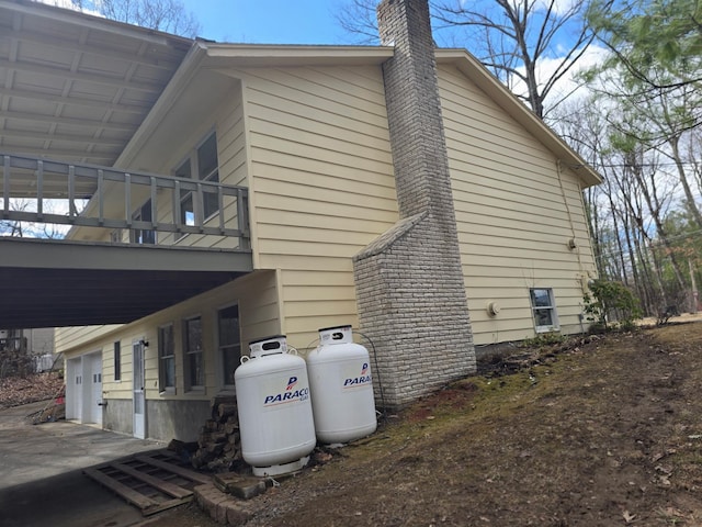 51 Glenerie Ln, Saugerties, NY 12477 - view of side of property featuring a chimney, a balcony, and a garage