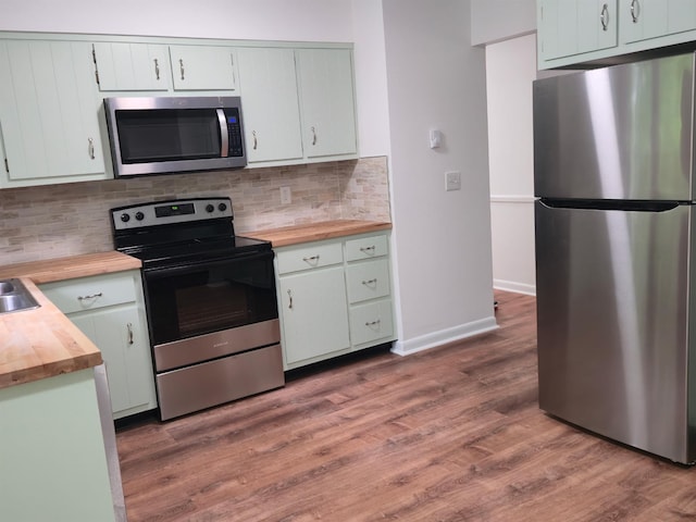51 Glenerie Ln, Saugerties, NY 12477 - kitchen featuring stainless steel appliances, butcher block countertops, wood finished floors, backsplash, and baseboards