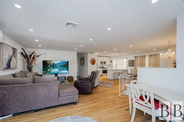 2394 National Dr, Brooklyn, NY 11234 - living area featuring recessed lighting, visible vents, a notable chandelier, and light wood-type flooring