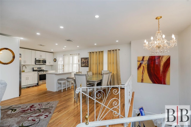 2394 National Dr, Brooklyn, NY 11234 - dining area featuring visible vents, light wood-style floors, recessed lighting, and a chandelier