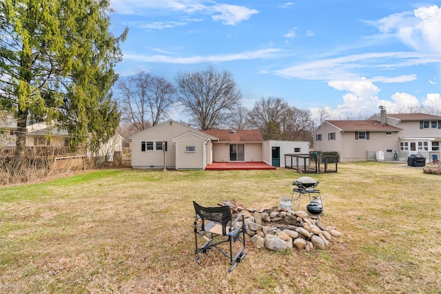 24 Patricia Ln, Washingtonville, NY 10992 - back of property with a lawn, an outdoor fire pit, fence, and a deck