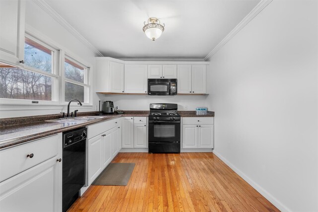 24 Patricia Ln, Washingtonville, NY 10992 - kitchen with white cabinets, ornamental molding, dark countertops, a sink, and black appliances
