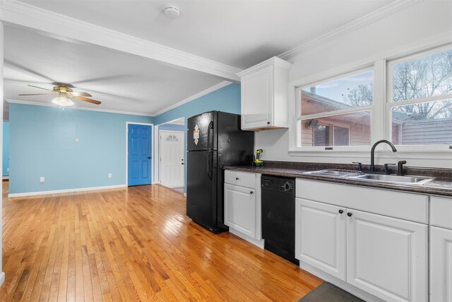 24 Patricia Ln, Washingtonville, NY 10992 - kitchen with light wood-type flooring, ornamental molding, a sink, dark countertops, and black appliances