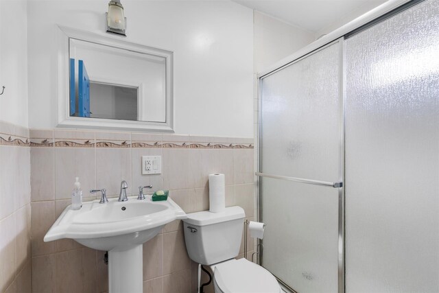 24 Patricia Ln, Washingtonville, NY 10992 - full bathroom with a stall shower, toilet, tile walls, and a wainscoted wall