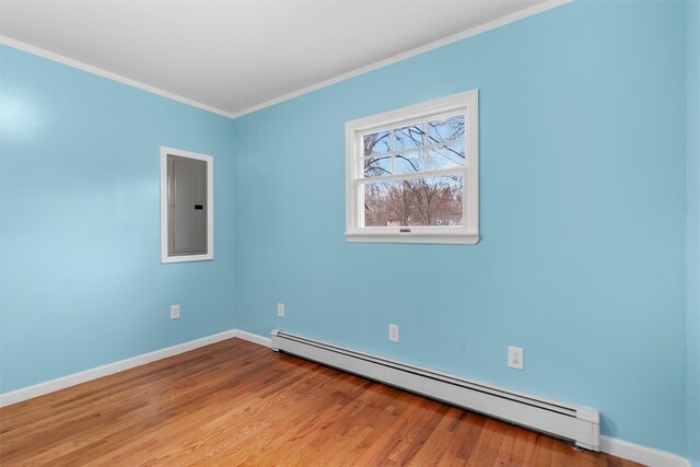24 Patricia Ln, Washingtonville, NY 10992 - unfurnished room with ornamental molding, wood finished floors, electric panel, and a baseboard radiator