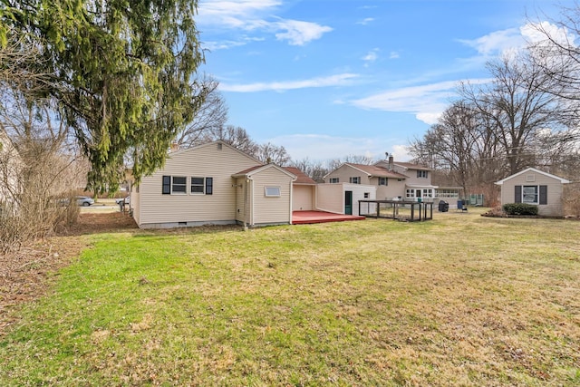 24 Patricia Ln, Washingtonville, NY 10992 - rear view of house with a wooden deck, a garage, and a lawn