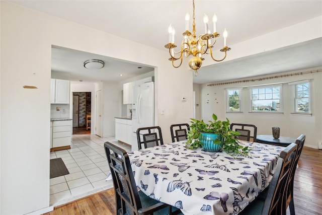 dining space with a chandelier and light wood finished floors