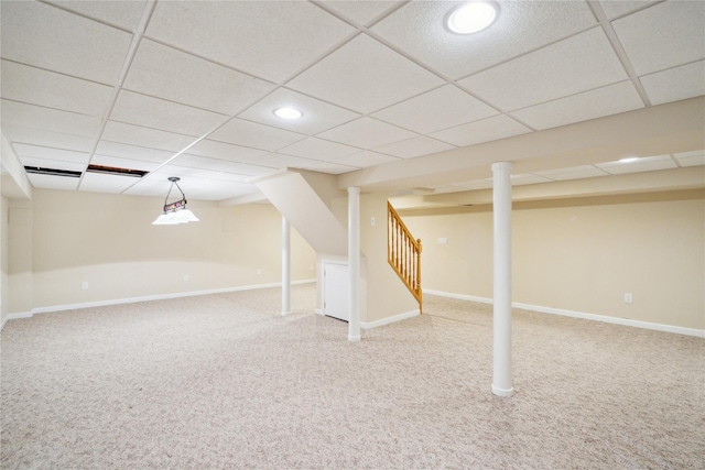 finished below grade area with stairway, carpet floors, baseboards, a paneled ceiling, and recessed lighting