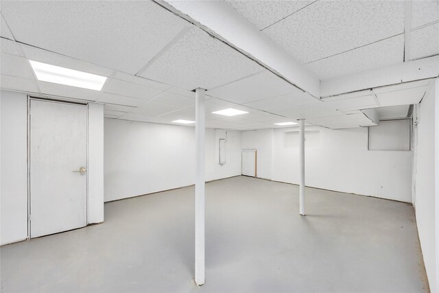 finished basement with a paneled ceiling