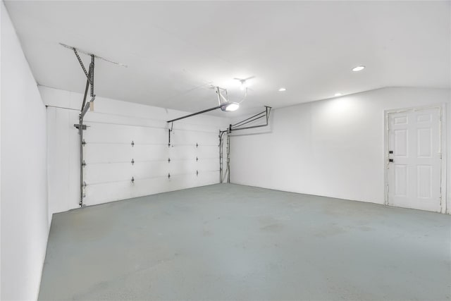 garage with recessed lighting and a garage door opener