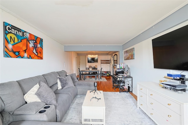 living room featuring wood finished floors and crown molding