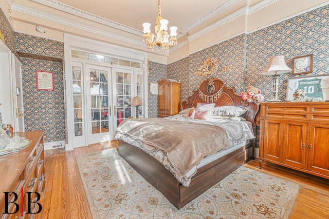 22 4th Pl, Brooklyn, NY 11231 - bedroom with ornamental molding, wallpapered walls, an inviting chandelier, light wood-style floors, and french doors