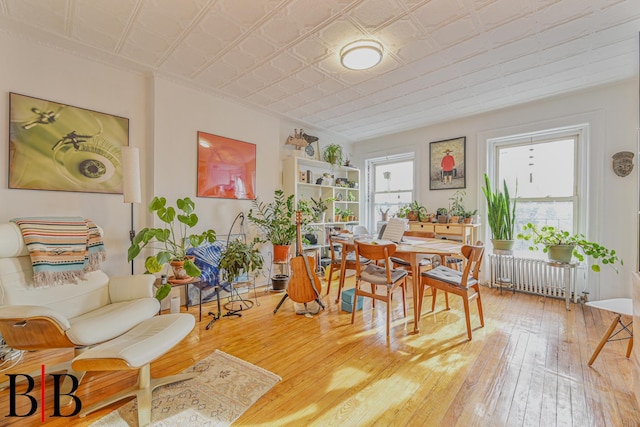 22 4th Pl, Brooklyn, NY 11231 - dining area with radiator heating unit, an ornate ceiling, light wood finished floors, and a wealth of natural light