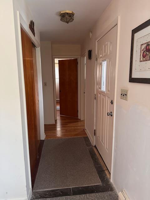 hallway featuring baseboards